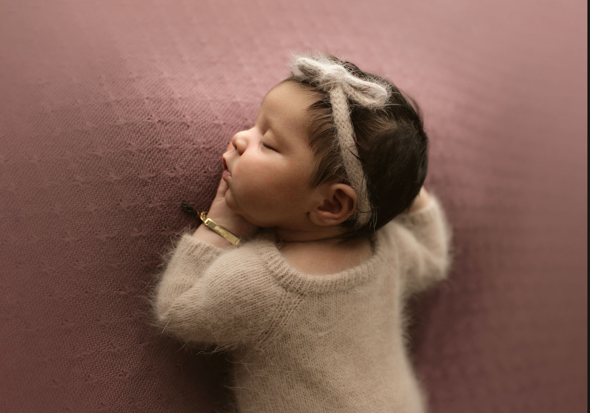 Newborn baby girl portrait on mauve
