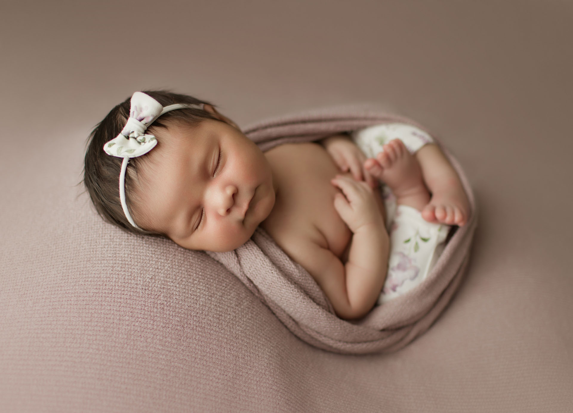 Newborn baby girl portrait on lavender