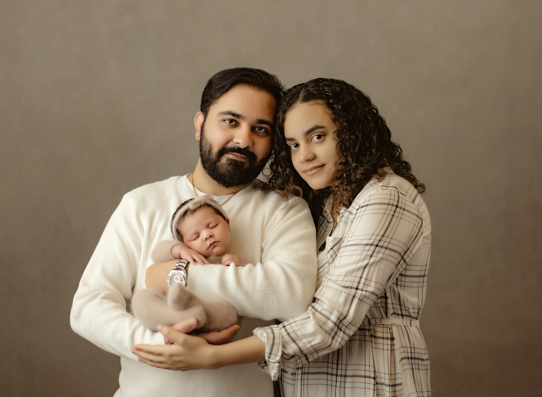 New parents holding newborn baby