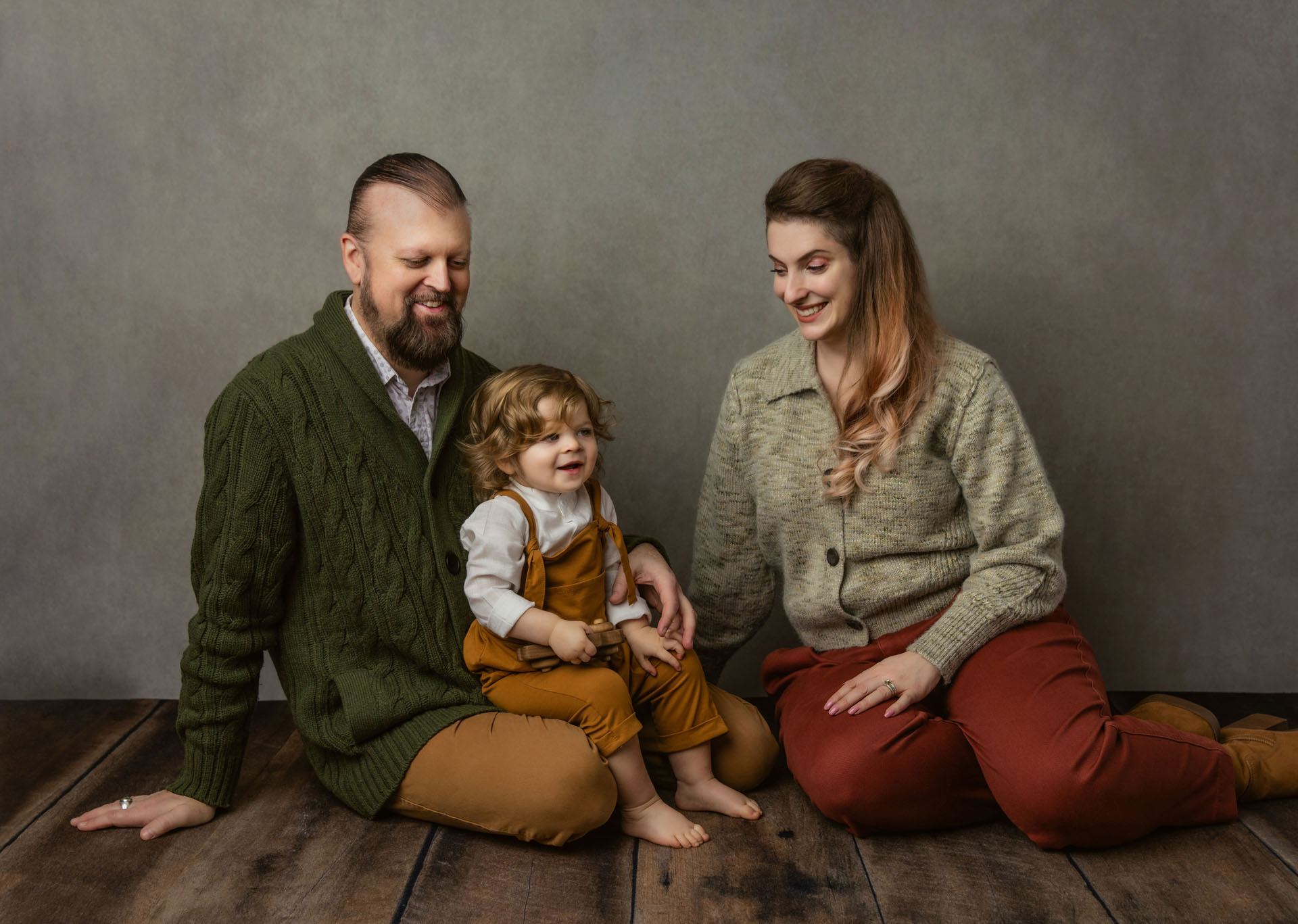 Portrait of laughing mom, dad and toddler