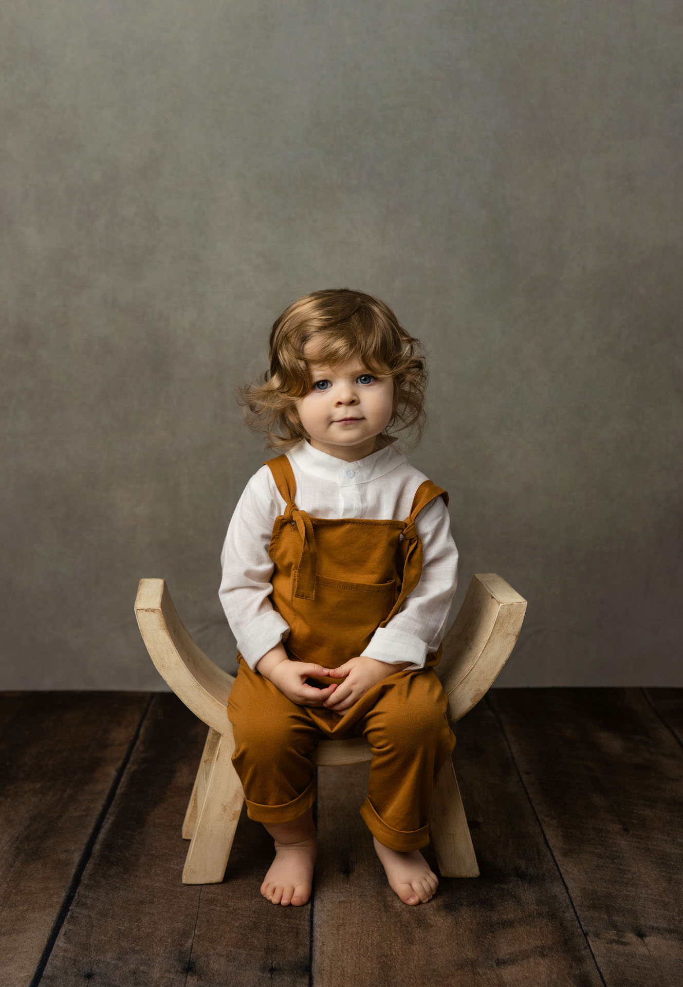 Portrait of toddler boy on bench
