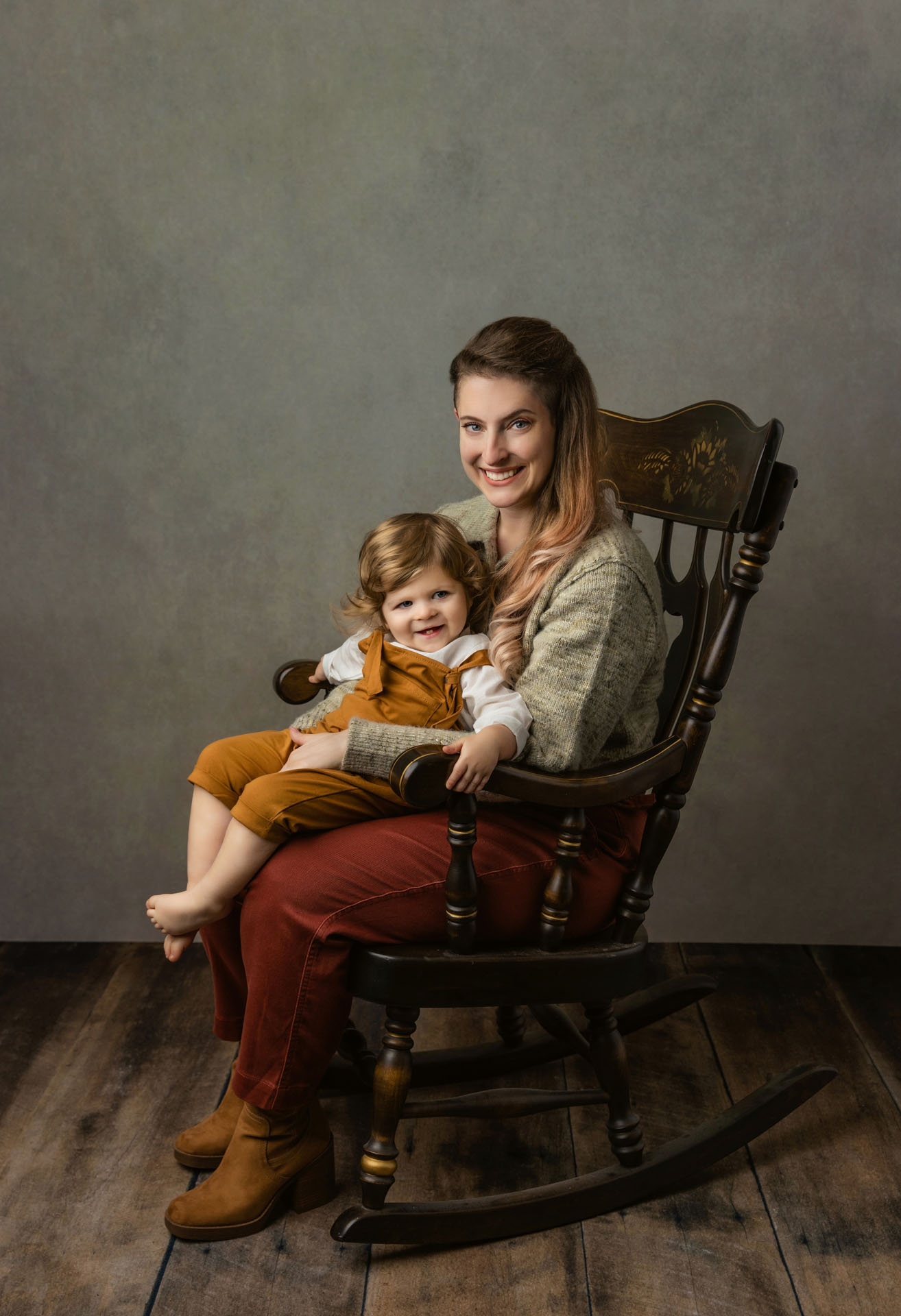 Portrait of toddler boy sitting on mom's lap