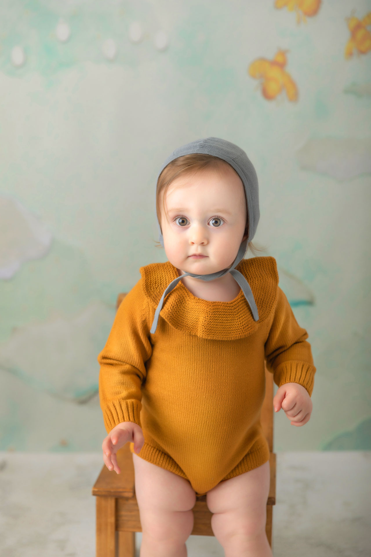 Milestone portrait of toddler in bonnet