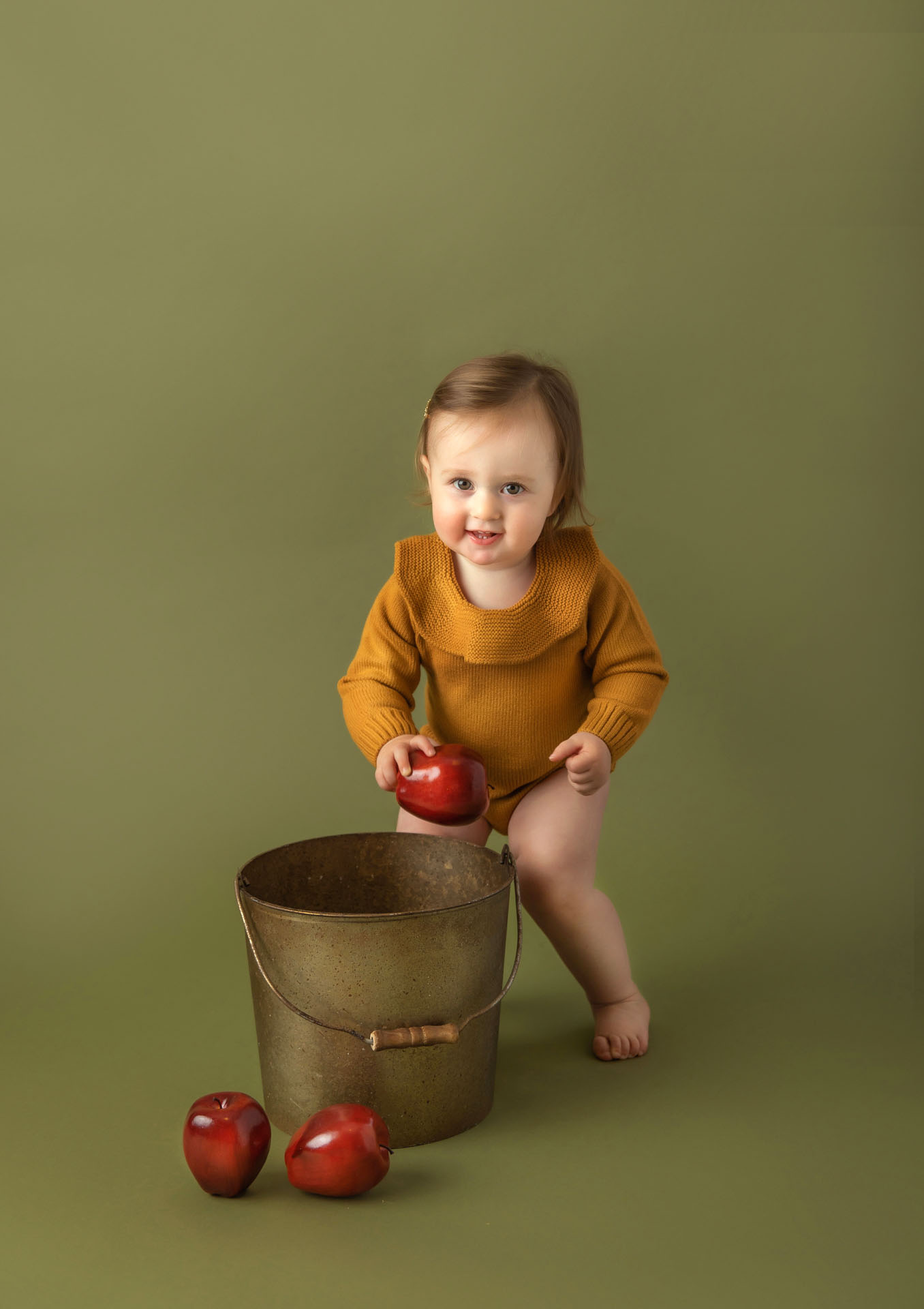 Milestone portrait of toddler with apple bucket