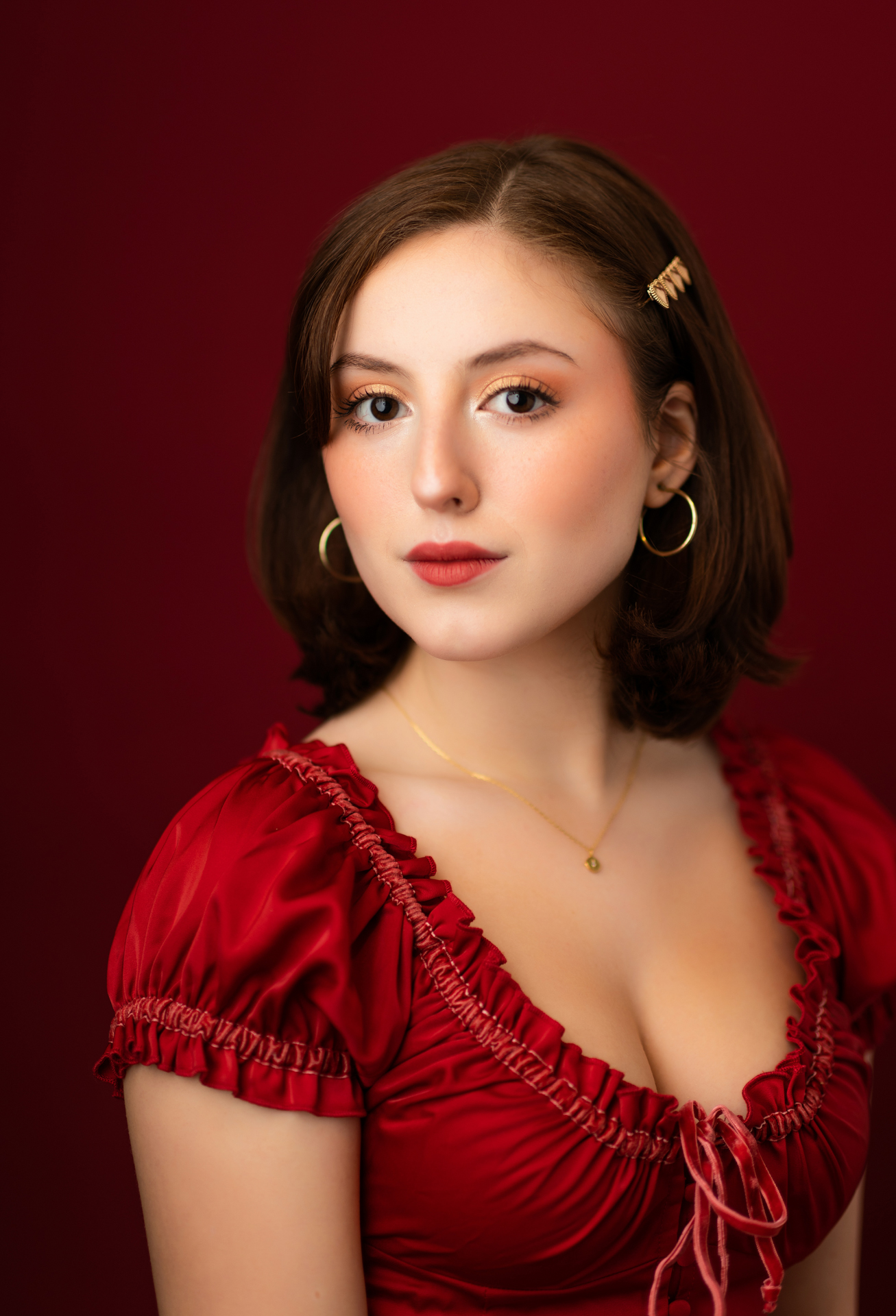 Professional musician portrait of young woman wearing red shirt on red background